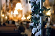 White flowers decorating a pillar during a church wedding